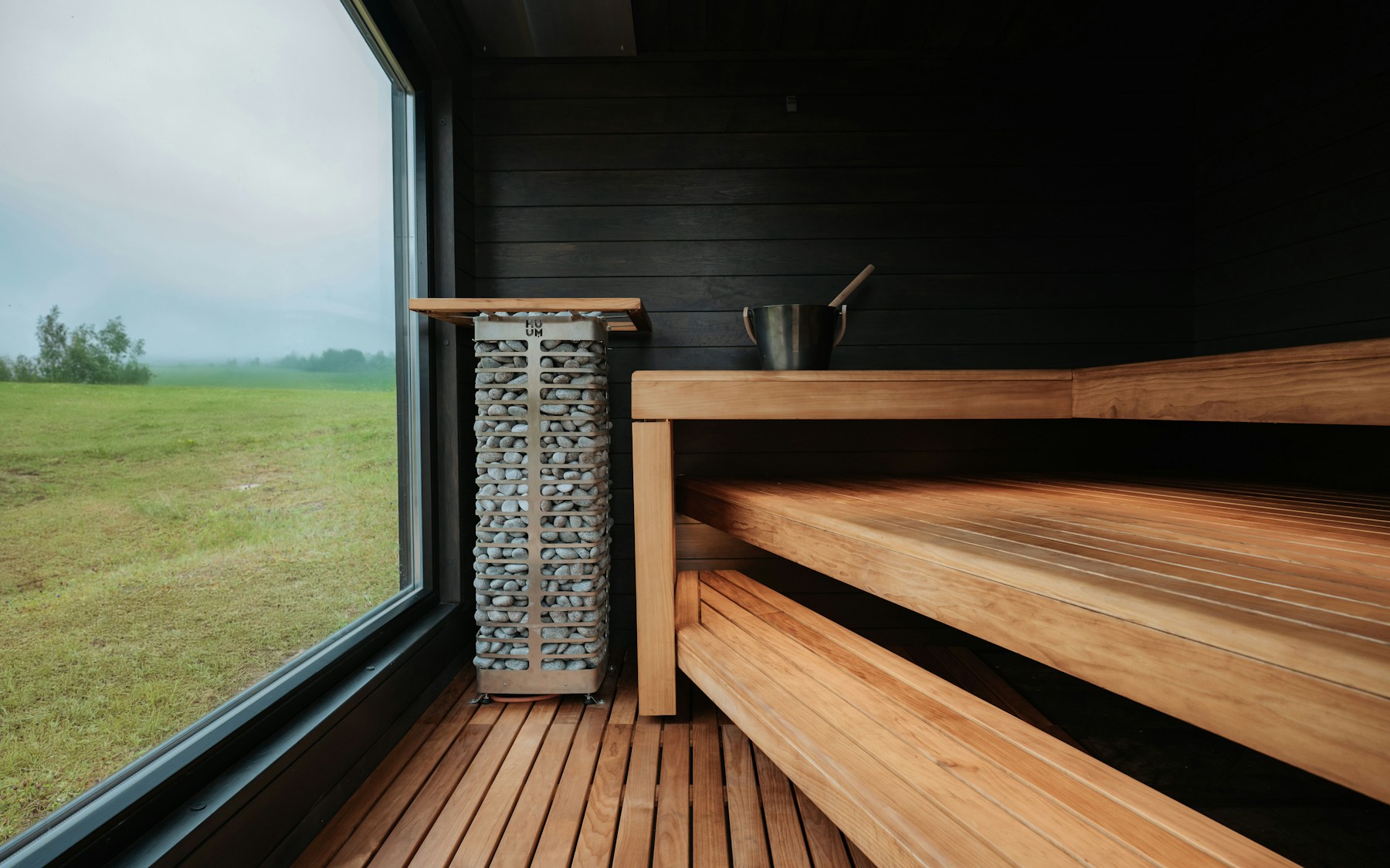 A wooden room of steam, stone at the hearth